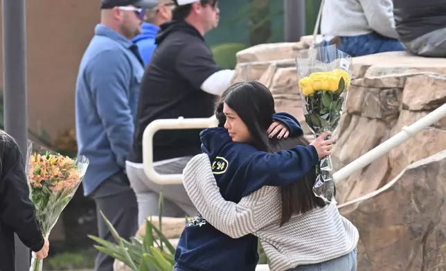 People attend a vigil at First Christian Church in Huntington Beach, Calif., on Friday, Jan. 3, 2025, for those killed in a small plane crash taking off from the Fullerton Municipal Airport the day before. (Jeff Gritchen/The Orange County Register via AP)