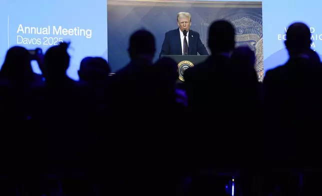 Attendees listen to a virtual speech delivered by U.S. president Donald Trump, at the Annual Meeting of World Economic Forum in Davos, Switzerland, Thursday, Jan. 23, 2025. (AP Photo/Markus Schreiber)