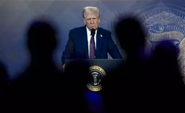 Attendees listen to a virtual speech delivered by U.S. president Donald Trump, at the Annual Meeting of World Economic Forum in Davos, Switzerland, Thursday, Jan. 23, 2025. (AP Photo/Markus Schreiber)