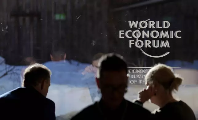 The logo of the World Economic Forum is displayed on a window at the congress center in Davos, Switzerland, Thursday, Jan. 23, 2025. (AP Photo/Markus Schreiber)
