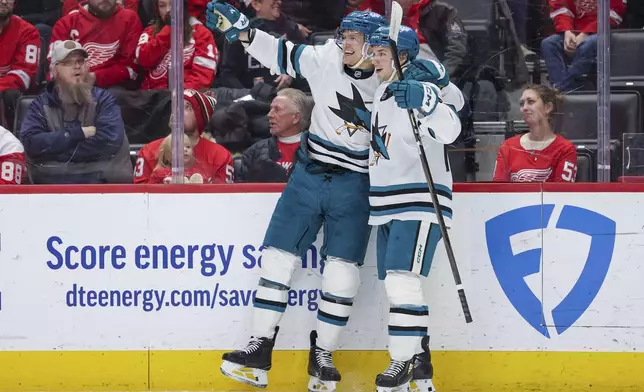 San Jose Sharks forwards Nico Strum and William Eklund celebrate after a goal in the first period against the Detroit Red Wings during an NHL hockey game, Tuesday, Jan. 14, 2025, in Detroit. (AP Photo/Mike Mulholland)