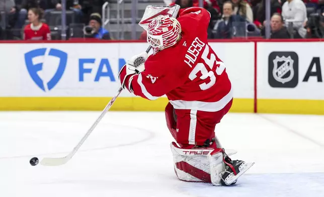 Detroit Red Wings goalie Ville Husso passes the puck away in the first period of an NHL hockey game against the San Jose Sharks on Tuesday, Jan. 14, 2025, in Detroit. (AP Photo/Mike Mulholland)