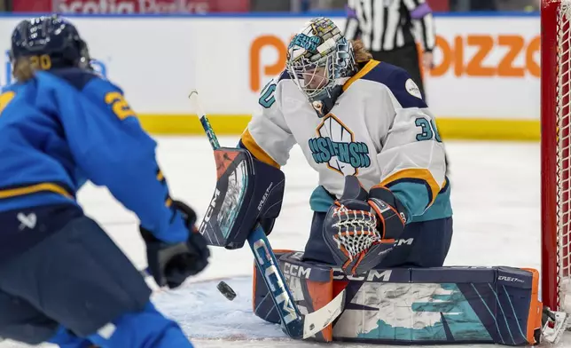 New York Sirens goaltender Corinne Schroeder (30) makes a save under pressure from Toronto Sceptres forward Sarah Nurse (20) during the first period of a PWHL hockey game in Toronto, Saturday Jan. 25, 2025. (Frank Gunn/The Canadian Press via AP)