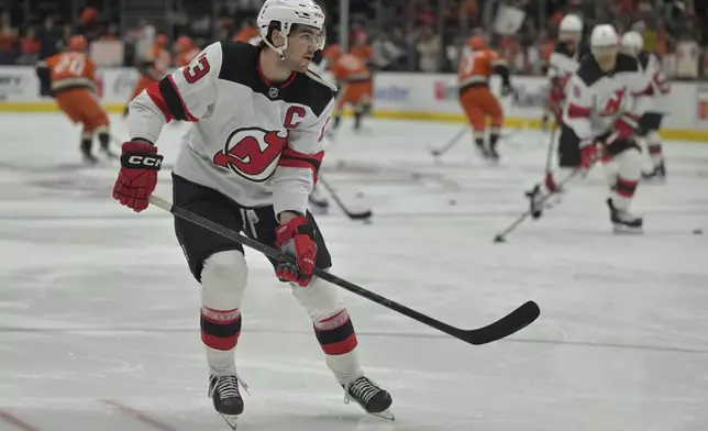 New Jersey Devils center Nico Hischier warms up prior to an NHL hockey game against the Anaheim Ducks, Tuesday, Dec. 31, 2024, in Anaheim, Calif. (AP Photo/Jayne-Kamin-Oncea)