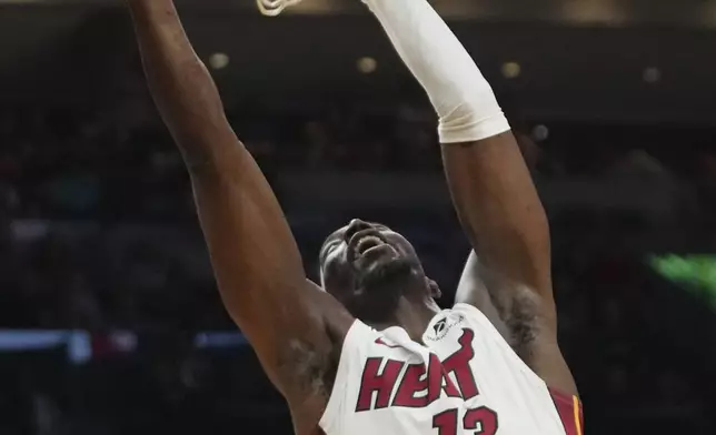 Miami Heat center Bam Adebayo (13) dunks during the first half of an NBA basketball game against the New Orleans Pelicans, Wednesday, Jan. 1, 2025, in Miami. (AP Photo/Lynne Sladky)