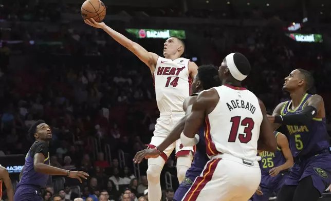 Miami Heat guard Tyler Herro (14) goes to the basket during the first half of an NBA basketball game against the New Orleans Pelicans, Wednesday, Jan. 1, 2025, in Miami. (AP Photo/Lynne Sladky)