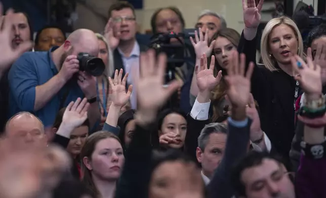 Reports raise their hands to ask questions during a press briefing with White House press secretary Karoline Leavitt at the White House, Tuesday, Jan. 28, 2025, in Washington. (AP Photo/Evan Vucci)