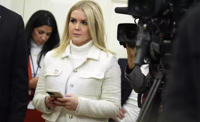 FILE - White House press secretary Karoline Leavitt watches as President Donald Trump signs executive orders in the Oval Office of the White House, Jan. 20, 2025, in Washington. (AP Photo/Evan Vucci, File)
