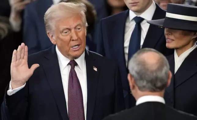 Donald Trump is sworn in as the 47th president of the United States by Chief Justice John Roberts as Melania Trump holds the Bible during the 60th Presidential Inauguration in the Rotunda of the U.S. Capitol in Washington, Monday, Jan. 20, 2025. (AP Photo/Julia Demaree Nikhinson, Pool)