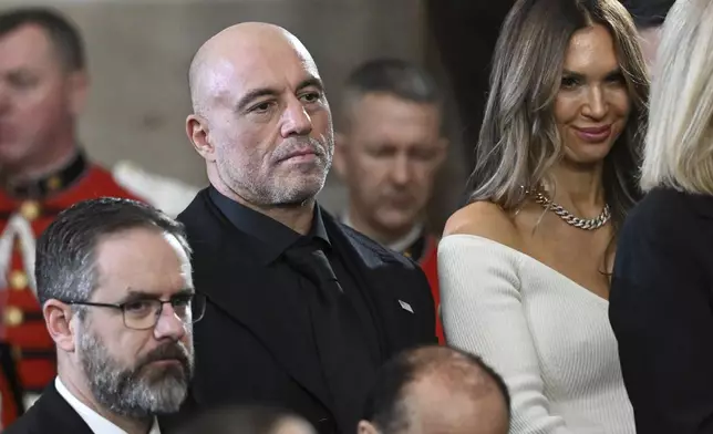 Joe Rogan stands for a benediction after President Donald Trump was sworn in during the 60th Presidential Inauguration in the Rotunda of the U.S. Capitol in Washington, Monday, Jan. 20, 2025. (Saul Loeb/Pool photo via AP)