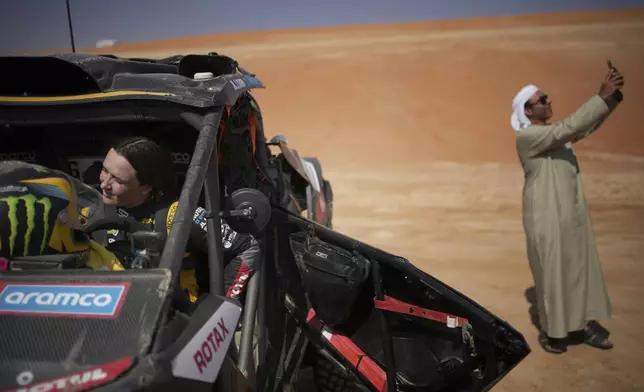 Sara Price of the U.S prepares at the start delayed due to fog during the eleventh stage of the Dakar Rally with start and finish in Shubaytah, Saudi Arabia, Thursday, Jan. 16, 2025. (AP Photo/Christophe Ena)