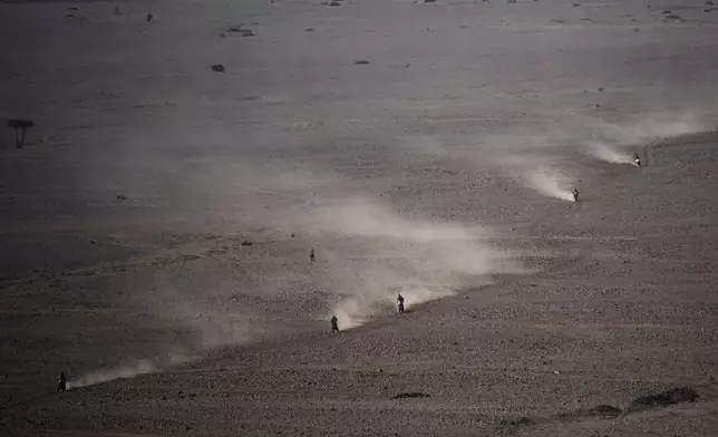 Riders compete during the ninth stage of the Dakar Rally between Riyadh and Haradh, Saudi Arabia, Tuesday, Jan. 14, 2025. (AP Photo/Christophe Ena)