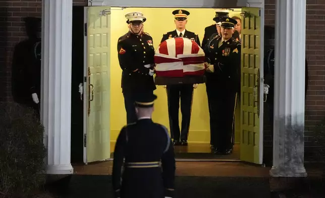 The flag-draped casket of former President Jimmy Carter is carried to a hearse after a funeral service at Maranatha Baptist Church, Thursday, Jan. 9, 2025, in Plains, Ga. (AP Photo/Mike Stewart)