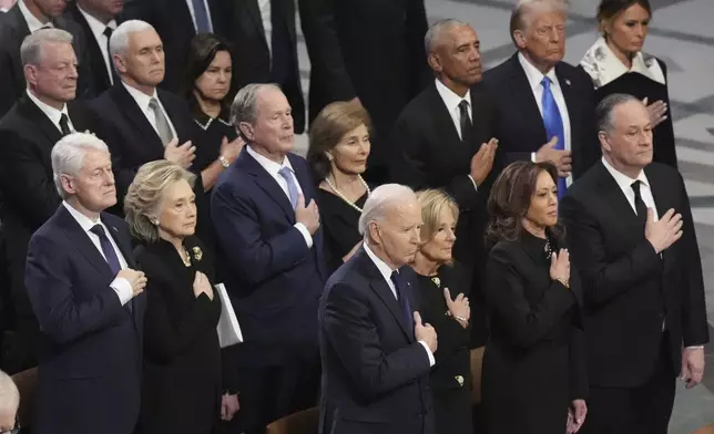 Front row, from left, President Joe Biden, first lady Jill Biden, Vice President Kamala Harris and second gentleman Doug Emhoff and second row from left, former President Bill Clinton, former Secretary of State Hillary Clinton, former President George W. Bush, Laura Bush, former President Barack Obama, President-elect Donald Trump and Melania Trump, stand during the state funeral for former President Jimmy Carter at Washington National Cathedral in Washington, Thursday, Jan. 9, 2025. (AP Photo/Jacquelyn Martin)