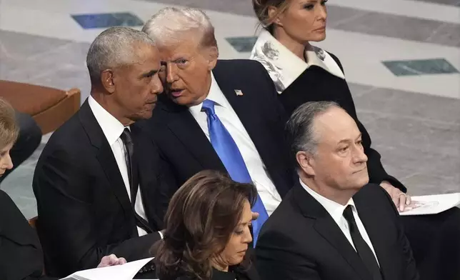 Former President Barack Obama talks with President-elect Donald Trump as Melania Trump listens and as Vice President Kamala Harris and second gentleman Doug Emhoff arrive, before the state funeral for former President Jimmy Carter at Washington National Cathedral in Washington, Thursday, Jan. 9, 2025. (AP Photo/Jacquelyn Martin)