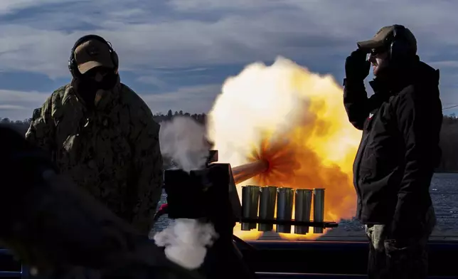 Chief Michael Marshalsea and TM1 Ian Knight fire a 40mm saluting battery during a 21-gun salute for former President Jimmy Carter at the Naval Submarine Base New London, Thursday, Jan. 9, 2025, in Groton, Conn. (AP Photo/Julia Demaree Nikhinson)