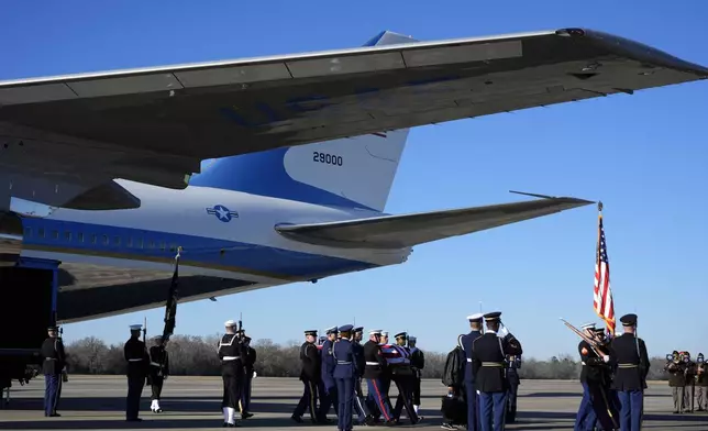 The flag-draped casket of former President Jimmy Carter carried by a joint services body bearer team from Special Air Mission 39 at Lawson Army Airfield, in Fort Moore, Ga., Thursday, Jan. 9, 2025. (AP Photo/Alex Brandon, Pool)