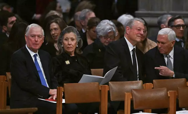 Former Vice President Dan Quayle, from left, his wife Marilyn Quayle, former Vice President Al Gore and former Vice President Mike Pence are seated before the casket of former President Jimmy Carter arrives for a state funeral at the National Cathedral, Thursday, Jan. 9, 2025, in Washington. (Ricky Carioti/The Washington Post via AP, Pool)