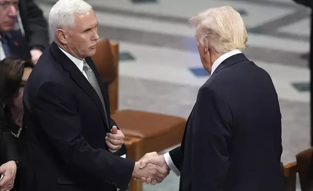 President-elect Donald Trump shakes hands with former Vice President Mike Pence before the state funeral for former President Jimmy Carter at Washington National Cathedral in Washington, Thursday, Jan. 9, 2025. (AP Photo/Jacquelyn Martin)