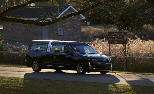 A hearse containing the flag-draped casket of former President Jimmy Carter arrives at Maranatha Baptist Church for a funeral service, Thursday, Jan. 9, 2025, in Plains, Ga. (AP Photo/Mike Stewart)