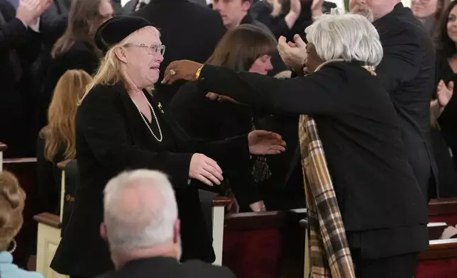 Amy Carter hugs her nanny Mary Prince during the funeral service for former President Jimmy Carter at Maranatha Baptist Church in Plains, Ga., Thursday, Jan. 9, 2025. Carter died Dec. 29 at the age of 100. (AP Photo/Alex Brandon, Pool)