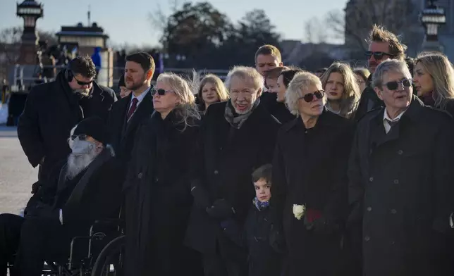 John Joseph "Jay" Kelly, from left, his wife Amy Carter, Jeff Carter, James "Chip" Carter, from right, his wife Becky, and members of the Carter family, watch before former President Jimmy Carter is taken from the U.S. Capitol in Washington to the National Cathedral for a state funeral, Thursday, Jan. 9, 2025. (Jeenah Moon/Pool via AP)