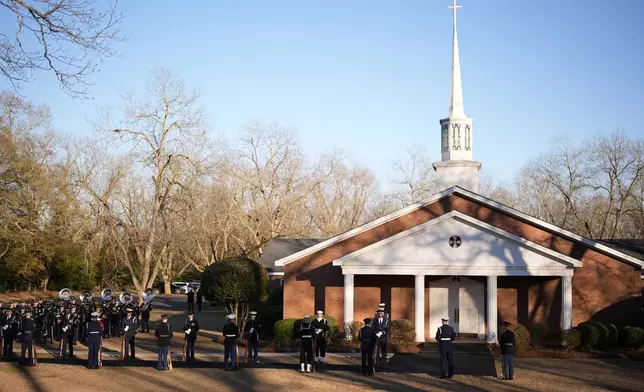 An honor guard and honor guard band march before the casket of former President Jimmy Carter arrives at Maranatha Baptist Church for a funeral service, Thursday, Jan. 9, 2025, in Plains, Ga. (AP Photo/Mike Stewart)