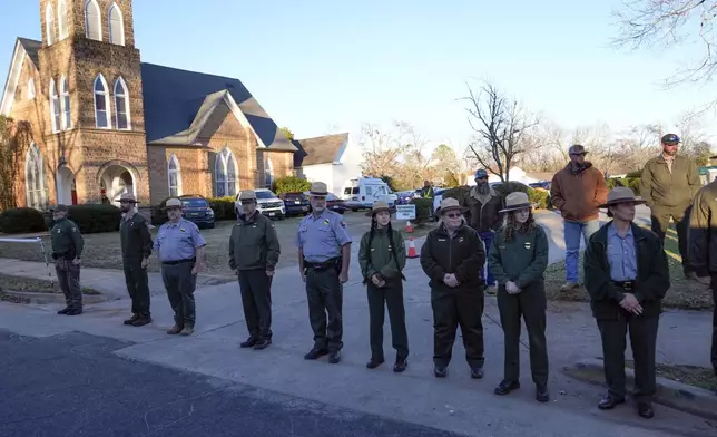 Member of the National Park Service watch as the hearse containing the flag-draped casket of former President Jimmy Carter passes through Plains, Ga., toward Maranatha Baptist Church for a funeral service Thursday, Jan. 9, 2025. (AP Photo/Alex Brandon, Pool)