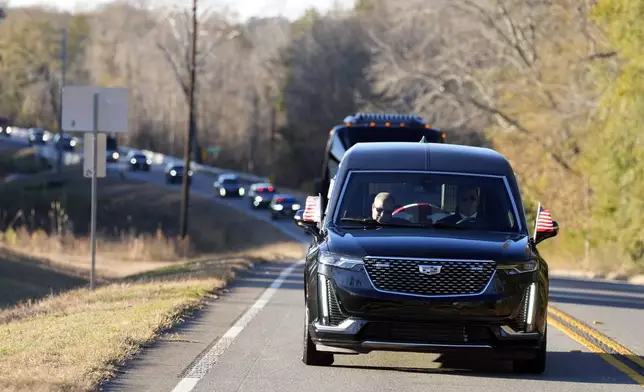 The hearse containing the flag-draped casket of former President Jimmy Carter approaches Palins, Ga., and Maranatha Baptist Church Thursday, Jan. 9, 2025. (AP Photo/Alex Brandon, Pool)