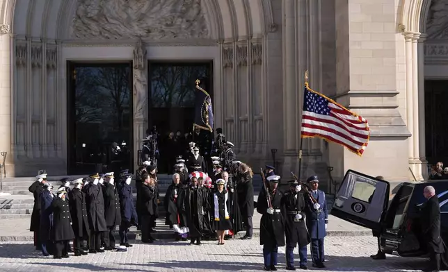 A joint services body bearer team carries the flag-draped casket of former President Jimmy Carter out of Washington National Cathedral, Thursday, Jan. 9, 2025, following a State Funeral. (AP Photo/Mark Schiefelbein)