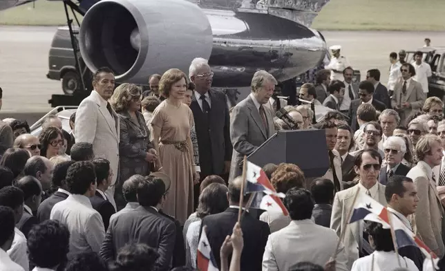 FILE - President Jimmy Carter speaks next to his wife Rosalynn upon arrival to Panama City to sign the Panama Canal Treaty, June 16, 1978. (AP Photo)