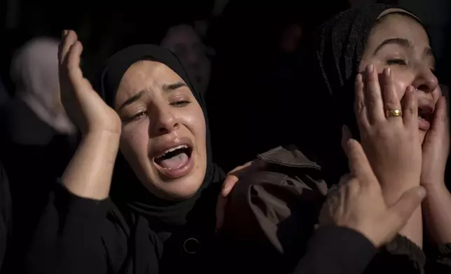 Relatives mourn during the funeral of Palestinian Muhammad Abu Amer, 18, who was killed at night in an Israeli army raid, in the West Bank refugee camp of Balata, Nablus, Saturday, Jan. 4, 2025. (AP Photo/Majdi Mohammed)