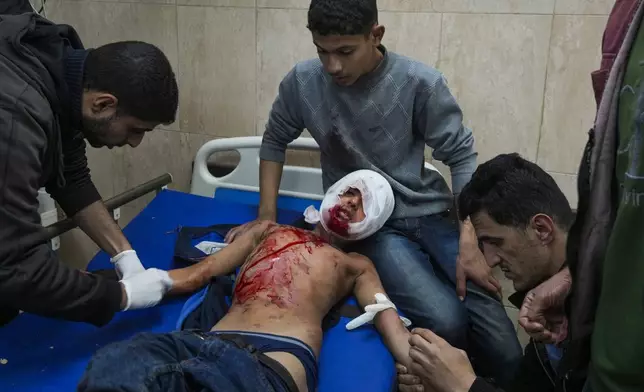 A wounded child receives treatment at Al-Aqsa Martyrs Hospital following Israeli army airstrikes, in Deir al-Balah, central Gaza Strip, Saturday Jan. 4, 2025.(AP Photo/Abdel Kareem Hana)