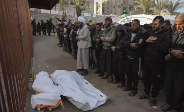 Palestinians attend funeral prayers for two of the ten people killed in overnight Israeli airstrikes on the Khan Younis refugee camp, southern Gaza Strip, Saturday, Jan. 4, 2025. (AP Photo/Abdel Kareem Hana)