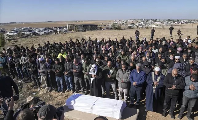 Members of the Bedouin community, part of Israel's Palestinian minority who have Israeli citizenship, attend the funeral of Yosef Al Zaydani in Rahat, southern Israel, Thursday, Jan. 9, 2025 after the Israeli military said his body of was recovered in an underground tunnel in southern Gaza Strip. (AP Photo/Mahmoud Illean)