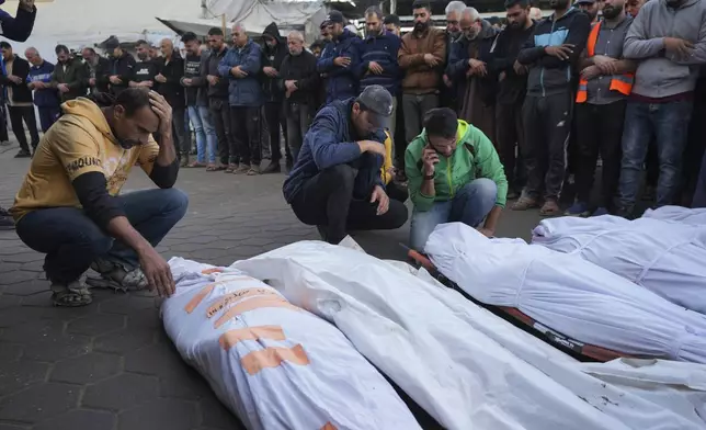 FILE - Palestinians mourn their relatives killed in the Israeli bombardment of Maghazi in the Gaza Strip, during their funeral at a hospital morgue in Deir al-Balah, Gaza, Thursday, Nov. 14, 2024. (AP Photo/Abdel Kareem Hana, File)