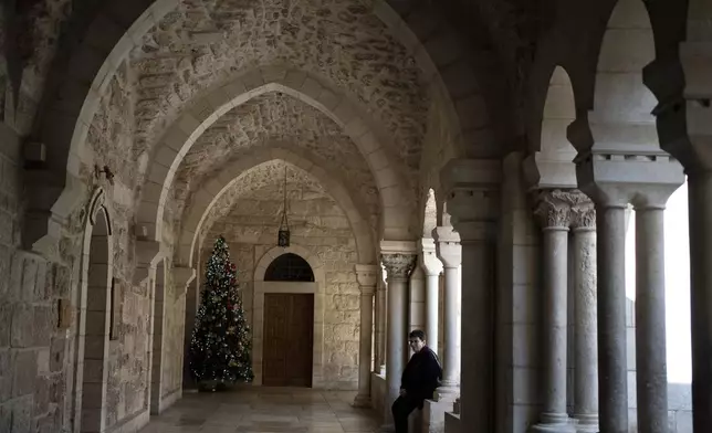 A lone Christmas tree is seen in the Church of the Nativity complex, where Christians believe Jesus Christ was born, ahead of Orthodox Christmas Eve mass in the West Bank city of Bethlehem, Monday, Jan. 6, 2025. (AP Photo/Maya Alleruzzo)