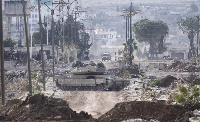 Israeli military armored vehicles block a road leading to the town of Quneitra, Syria, Sunday, Jan. 5, 2025. (AP Photo/Mosa'ab Elshamy)