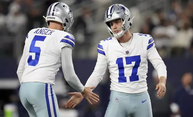 Dallas Cowboys' Bryan Anger (5) and Brandon Aubrey (17) celebrate after Aubrey kicked a field goal in the first half of an NFL football game against the Tampa Bay Buccaneers in Arlington, Texas, Sunday, Dec. 22, 2024. (AP Photo/Julio Cortez)