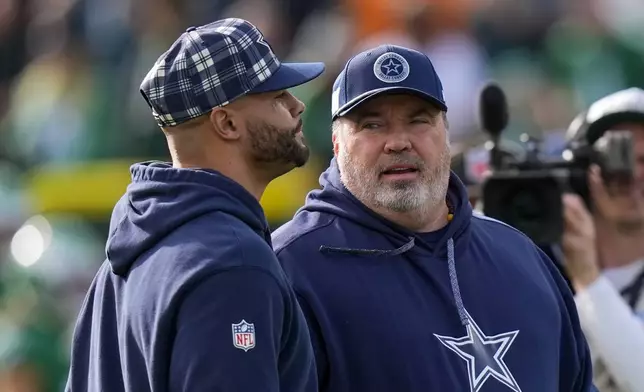 Dallas Cowboys head coach Mike McCarthy, right, talks with quarterback Dak Prescott prior to an NFL football game against the Philadelphia Eagles, Sunday, Dec. 29, 2024, in Philadelphia. (AP Photo/Chris Szagola)