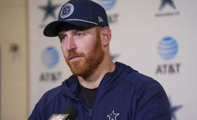 Dallas Cowboys quarterback Cooper Rush speaks to reporters following an NFL football game against the Philadelphia Eagles, Sunday, Dec. 29, 2024, in Philadelphia. The Eagles won 41-7. (AP Photo/Chris Szagola)