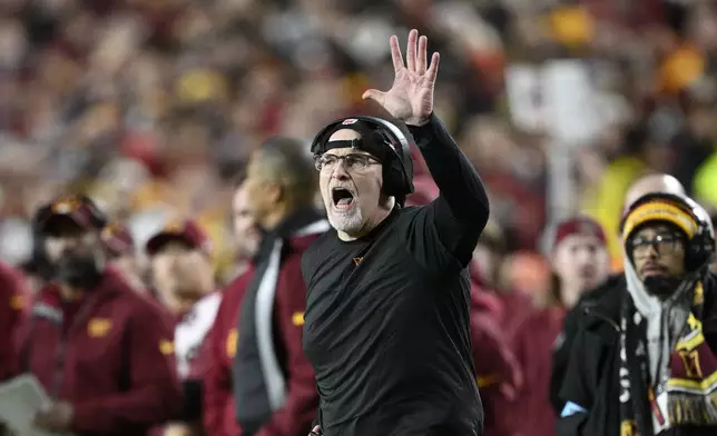 Washington Commanders head coach Dan Quinn calls out from the sideline during the second half of an NFL football game against the Atlanta Falcons, Sunday, Dec. 29, 2024, in Landover, Md. (AP Photo/Nick Wass)