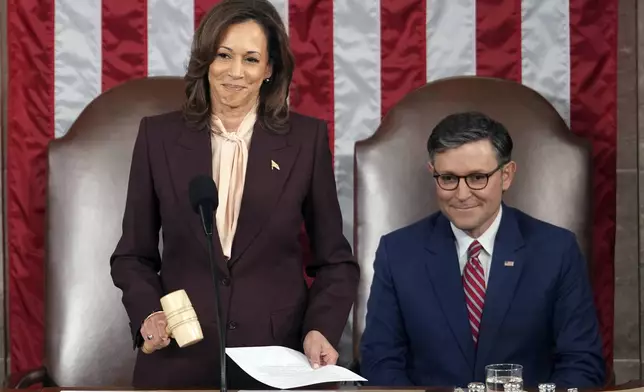 Vice President Kamala Harris reads the results as House Speaker Mike Johnson of La., listens during a joint session of Congress to confirm the Electoral College votes, affirming President-elect Donald Trump's victory in the presidential election, Monday, Jan. 6, 2025, at the U.S. Capitol in Washington. (AP Photo/Matt Rourke)