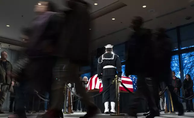 Mourners view the casket of former President Jimmy Carter as he lies in repose at the Jimmy Carter Presidential Library and Museum in Atlanta, Sunday, Jan. 5, 2025. Carter died Dec. 29 at the age of 100. (AP Photo/Alex Brandon, Pool)