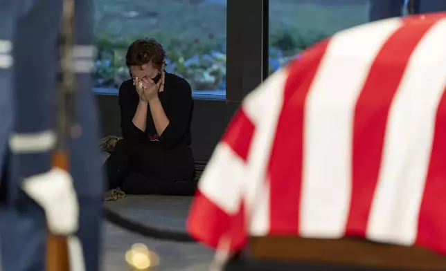 Annabeth Mellon becomes emotional while viewing the casket of former President Jimmy Carter as he lies in repose at the Jimmy Carter Presidential Library and Museum in Atlanta, Monday, Jan. 6, 2025. Carter died Dec. 29 at the age of 100. (AP Photo/Alex Brandon, Pool)