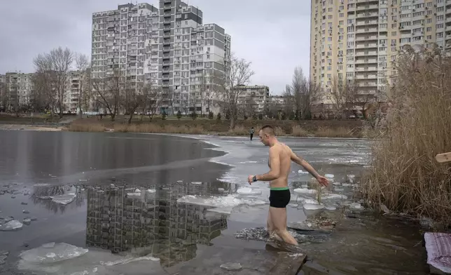 An Orthodox believer walks into icy water during celebrations of Epiphany in Kyiv, Ukraine, Monday, Jan. 6, 2025. (AP Photo/Efrem Lukatsky)