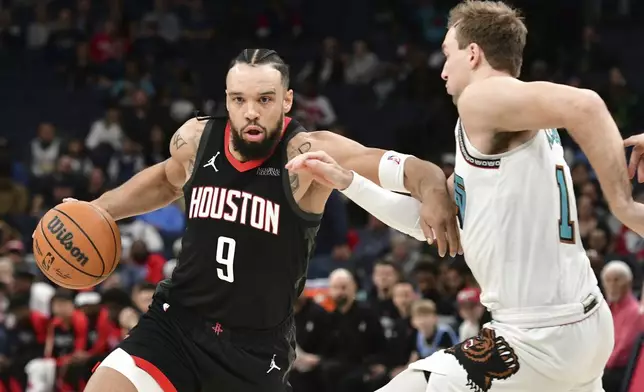 Houston Rockets forward Dillon Brooks (9) handles the ball against Memphis Grizzlies guard Luke Kennard in the first half of an NBA basketball game Thursday, Jan. 30, 2025, in Memphis, Tenn. (AP Photo/Brandon Dill)