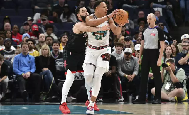 Memphis Grizzlies guard Desmond Bane (22) handles the ball against Houston Rockets guard Fred VanVleet (5) in the first half of an NBA basketball game Thursday, Jan. 30, 2025, in Memphis, Tenn. (AP Photo/Brandon Dill)
