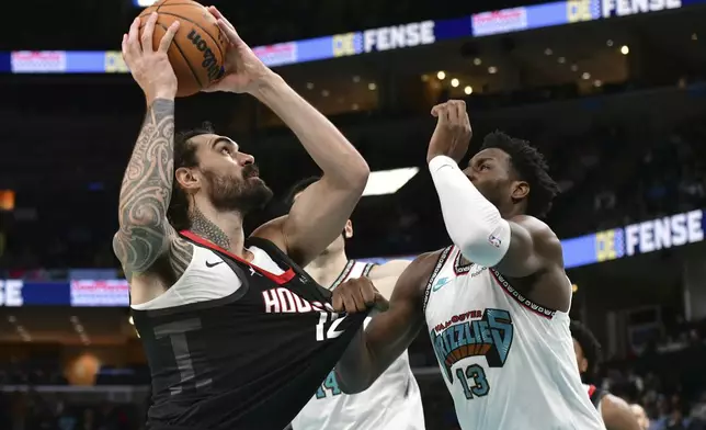 Houston Rockets center Steven Adams (12) shoots against Memphis Grizzlies forward Jaren Jackson Jr. (13) in the first half of an NBA basketball game Thursday, Jan. 30, 2025, in Memphis, Tenn. (AP Photo/Brandon Dill)