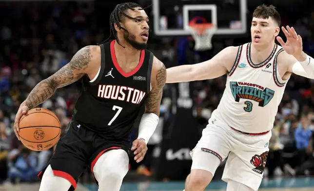 Houston Rockets forward Cam Whitmore (7) handles the ball against Memphis Grizzlies forward Jake LaRavia (3) in the first half of an NBA basketball game Thursday, Jan. 30, 2025, in Memphis, Tenn. (AP Photo/Brandon Dill)
